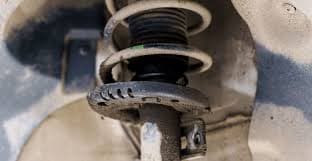 Leaking hydraulic shock absorber and torn rubber bushing